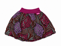 A kids' flared skirt featuring a vibrant magenta waistband and an all-over African dot art pattern in pink, purple, black, and white.