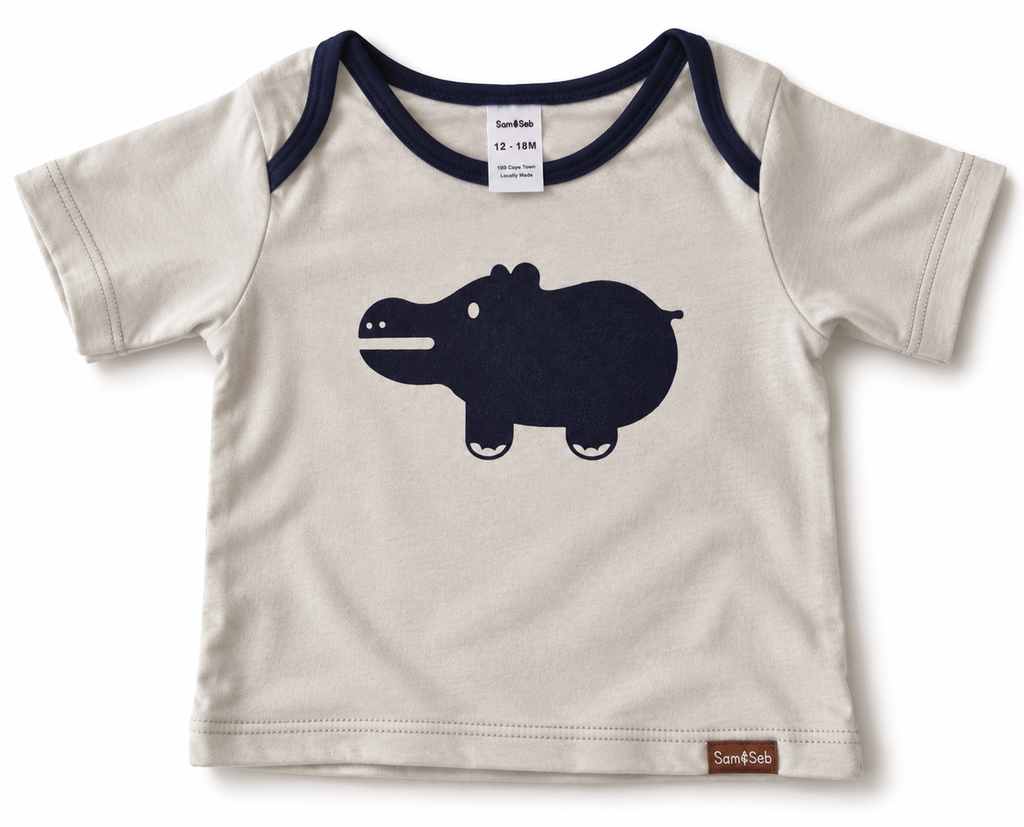 A baby t-shirt by Sam & Seb, featuring an off-white body with dark navy blue raglan shoulder trim and a large navy blue hippo graphic on the front.