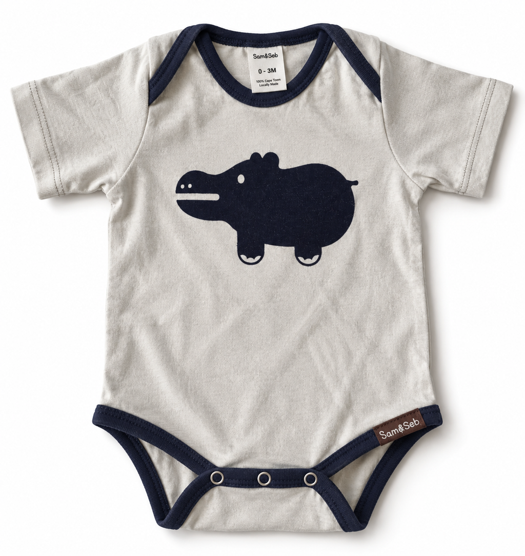 A short-sleeve baby bodysuit in off-white with navy blue trim and a dark navy hippo graphic on the chest. The brand 'Sam & Seb' is visible on the inner neck label and the bottom hem tag.