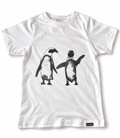 A white short-sleeve crewneck t-shirt featuring a black and white graphic print of two penguins on the front. A small brown brand tag is visible on the bottom right hem.